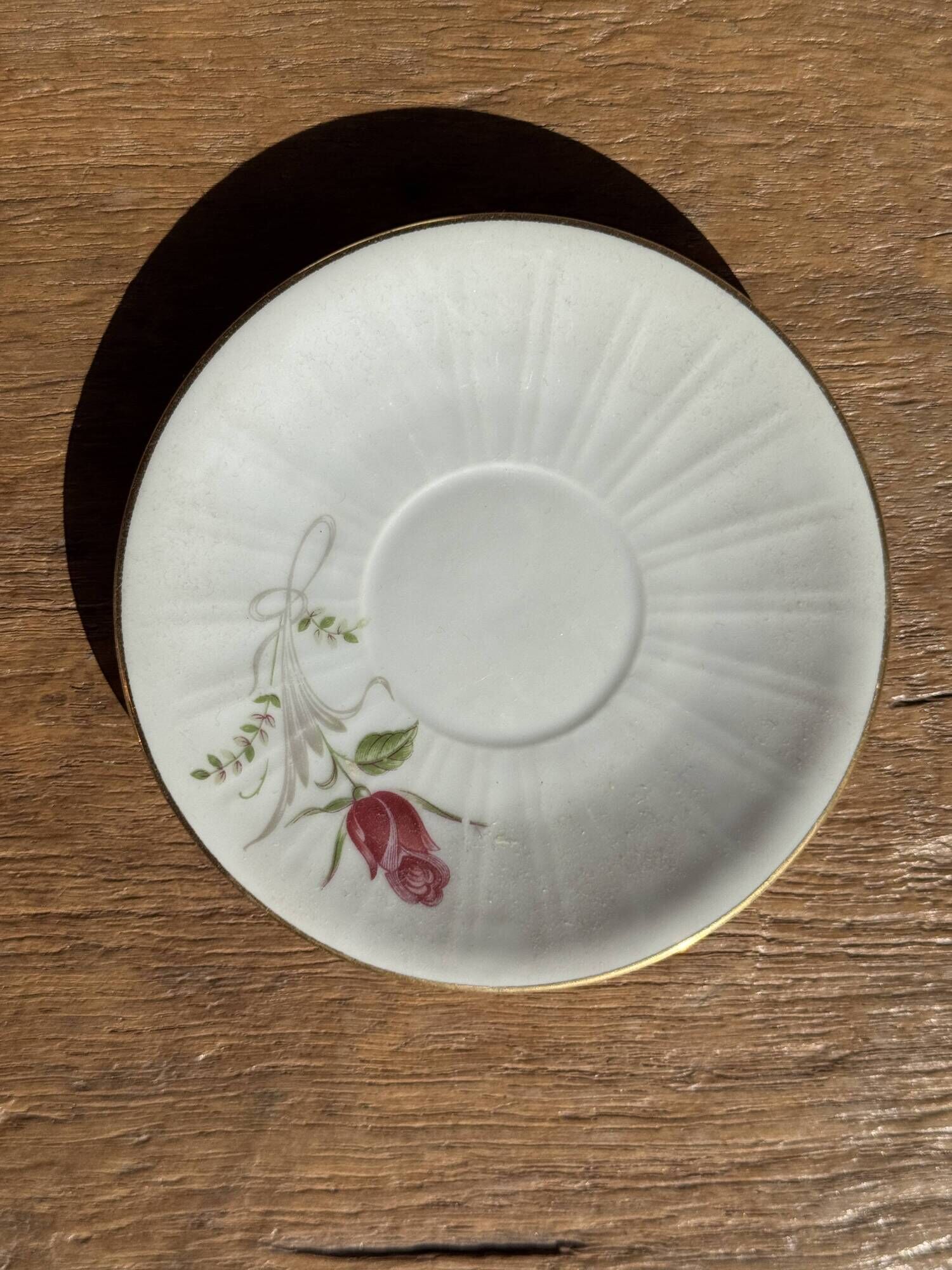 Pair of white porcelain cups from ADP France with a floral pattern and their s