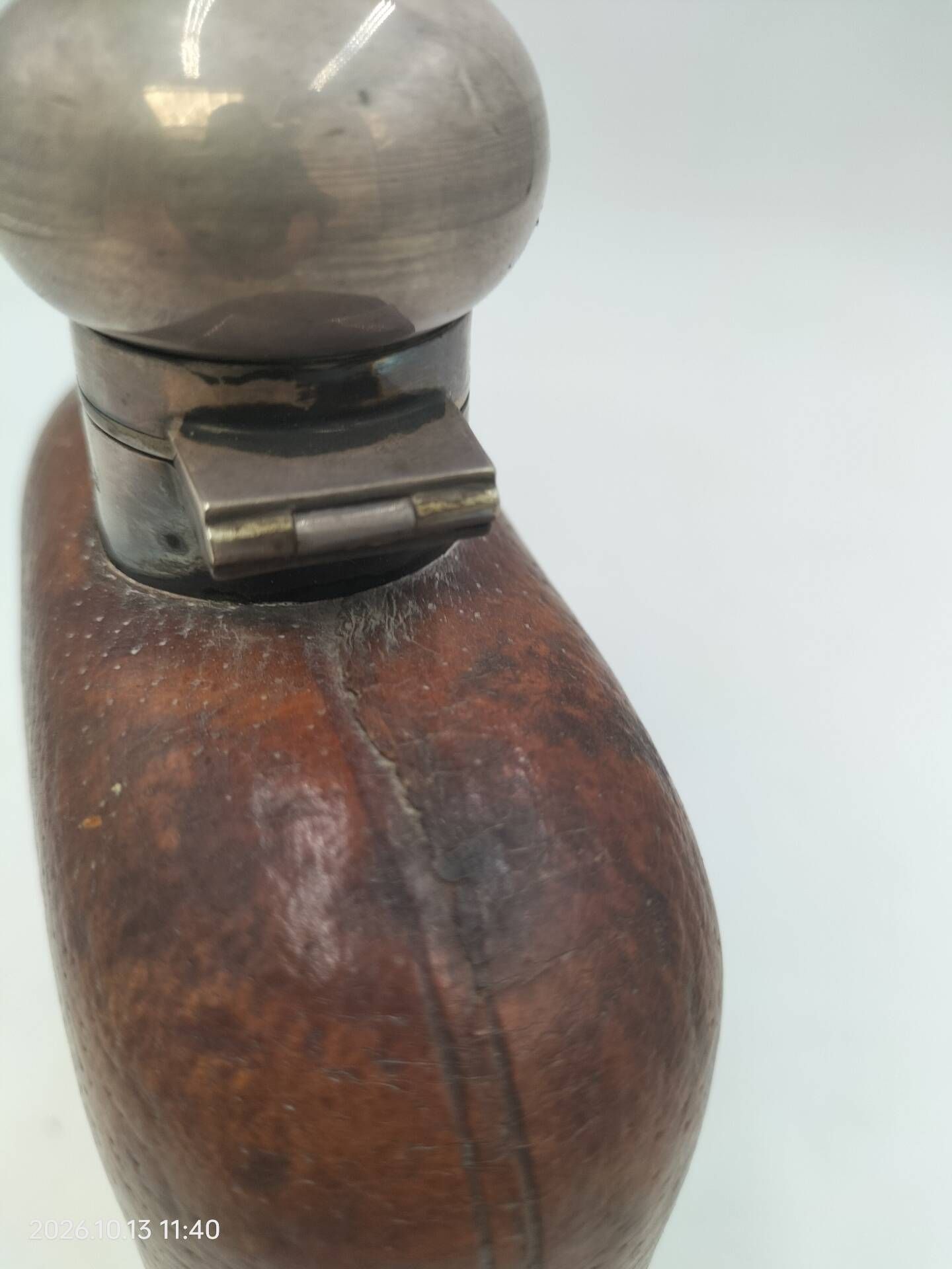 Silver-plated metal flask with leather and glass