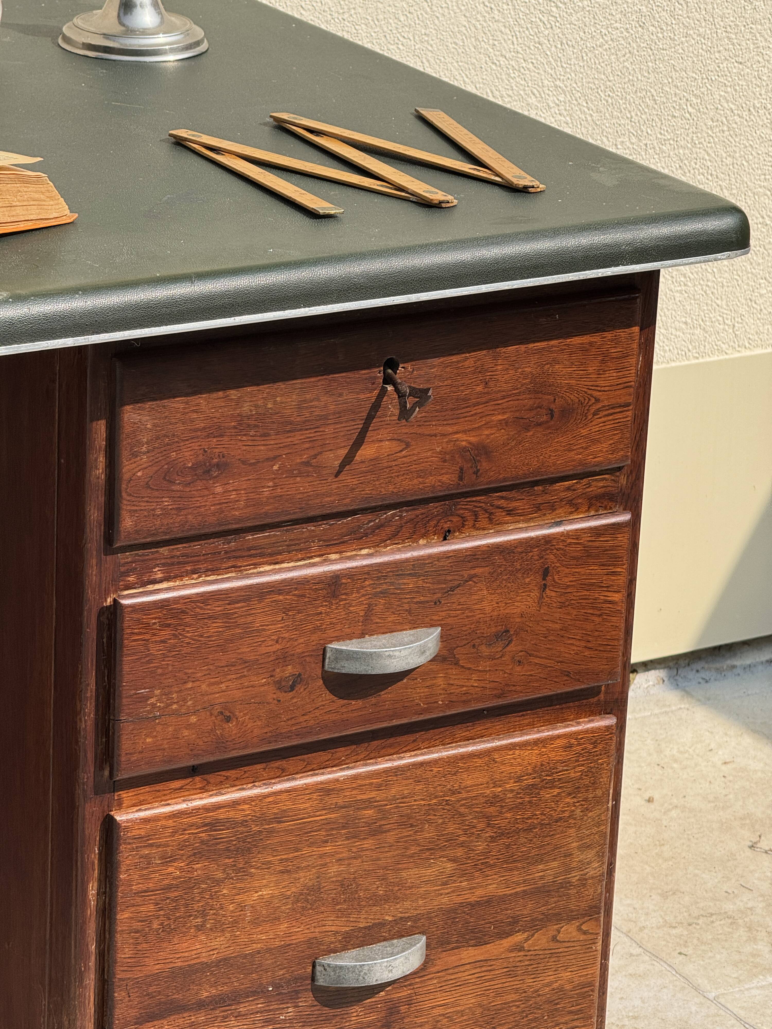 Modernist desk in wood and green moleskin upholstery
