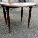 Antique round mahogany table, turned and fluted legs