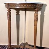 Half-moon console in Louis XVI style made of carved wood.