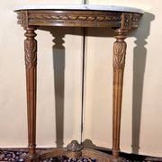 Half-moon console in Louis XVI style made of carved wood.
