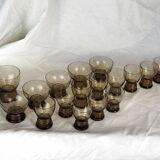 Set of 17 black smoked glasses on geometric engraving stand - 70s