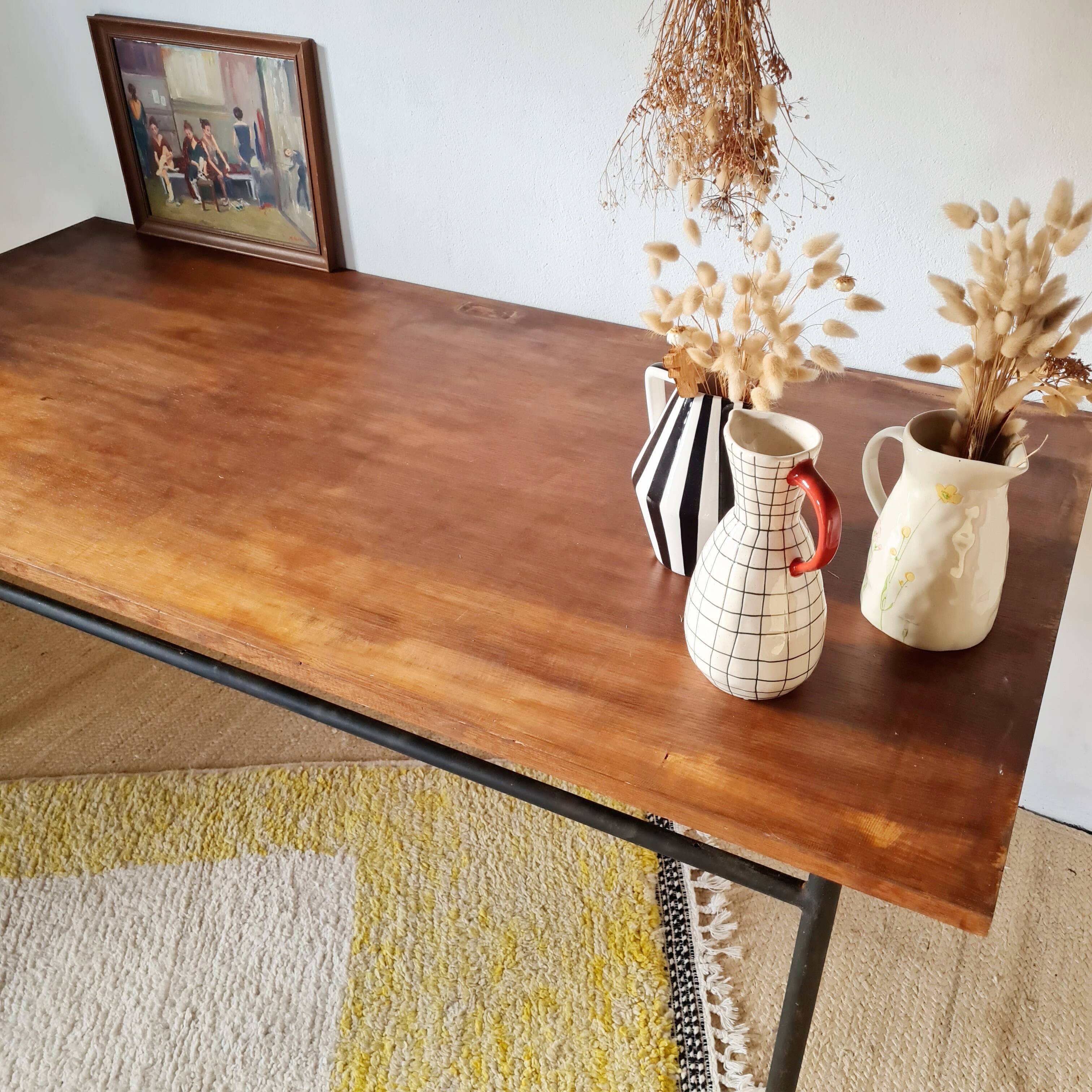 Metal tubular base table with a wooden top.
