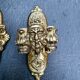 Pair of bronze wall sconces with mask, signed L. Pinet, Art Nouveau period.