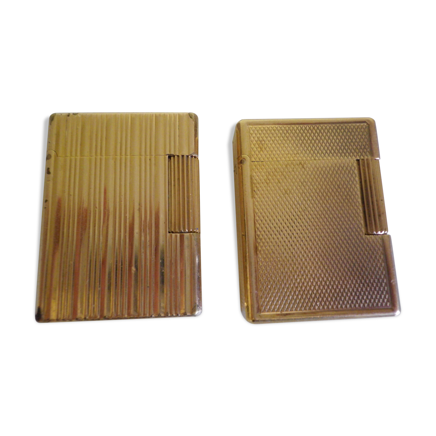 2 st dupont lighters, gold plated, punches, numbered, 1 striated pattern, 1 hammered pattern, 70s