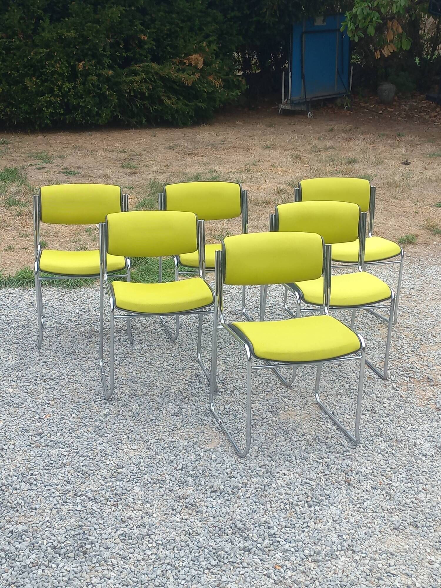 Set of 6 designer chairs with wooden seats and backs, chrome legs.