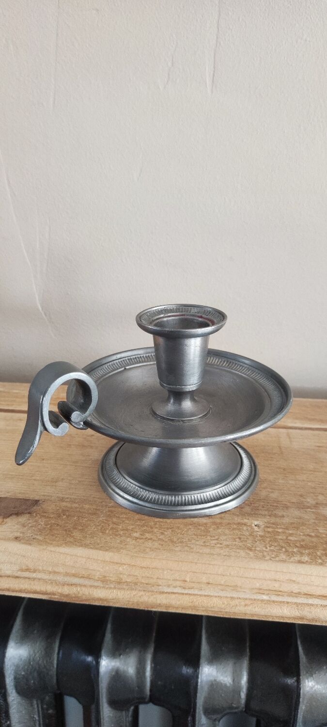 Tin hand candle holder.