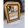 19th-century mirror with faux wood and gilded stucco.