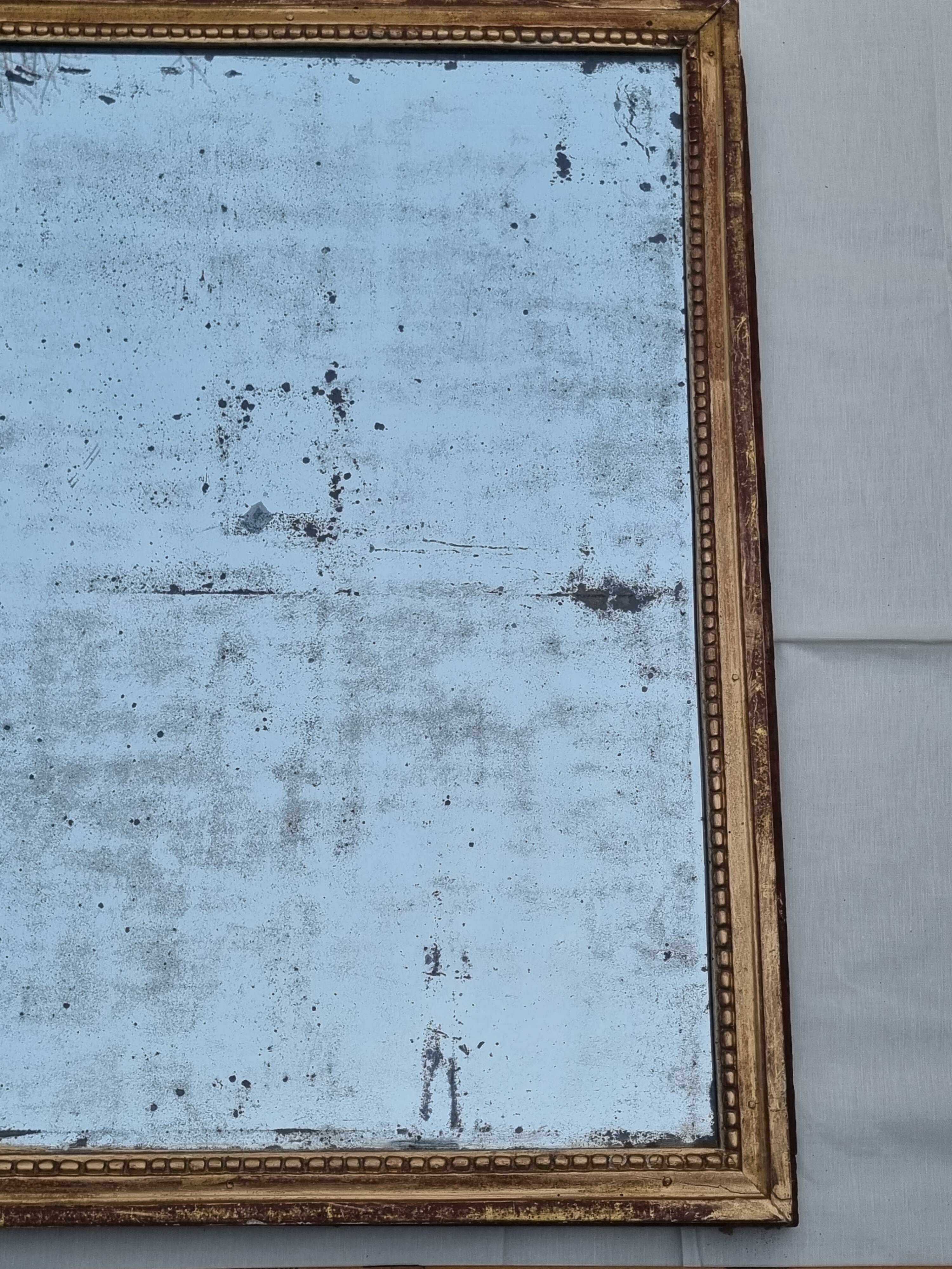 Antique mirror in a gilded wooden frame in the Louis XVI style, 19th century, 62x78 cm.