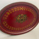 Old oval plate in painted red tin - floral decoration - early 20th century -