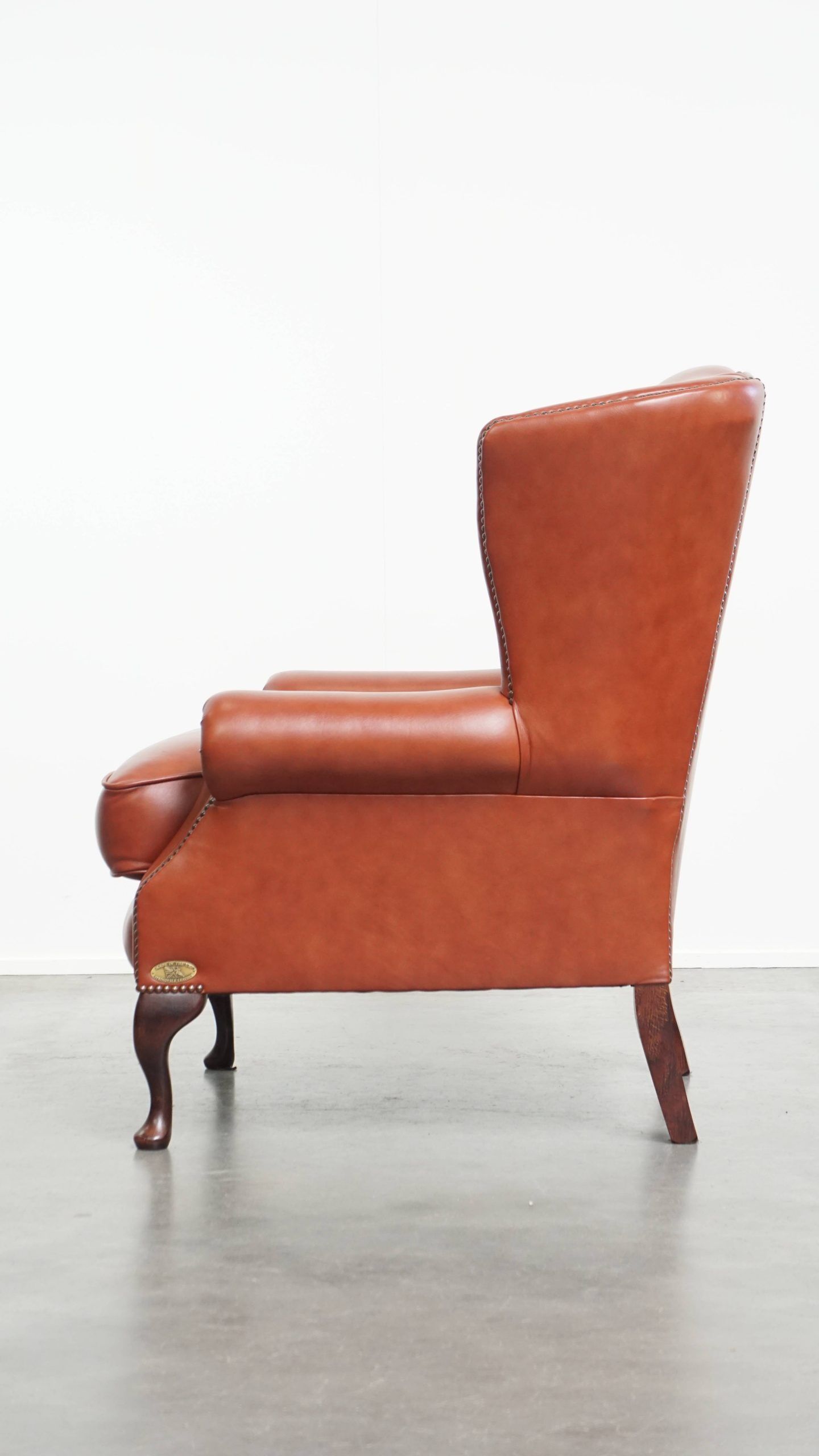 Elegant smooth English cowhide leather Chesterfield wingback armchair