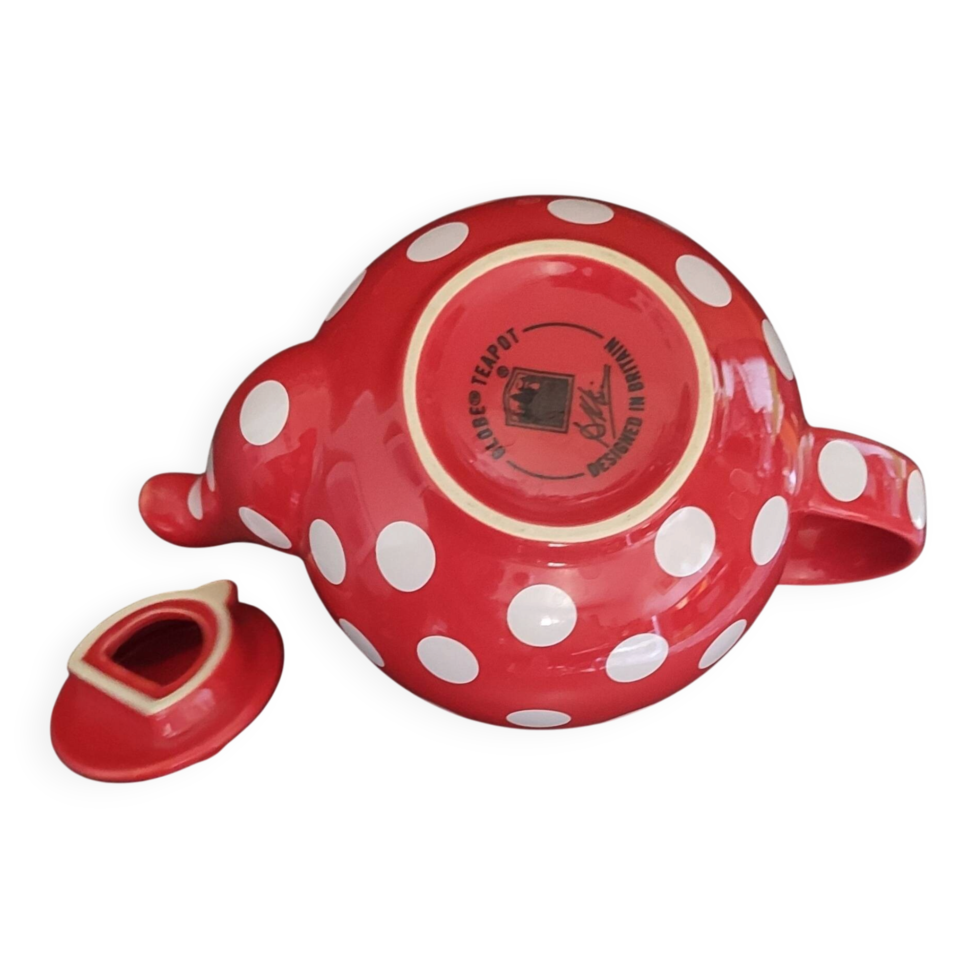 Pretty round English teapot with red polka dots.