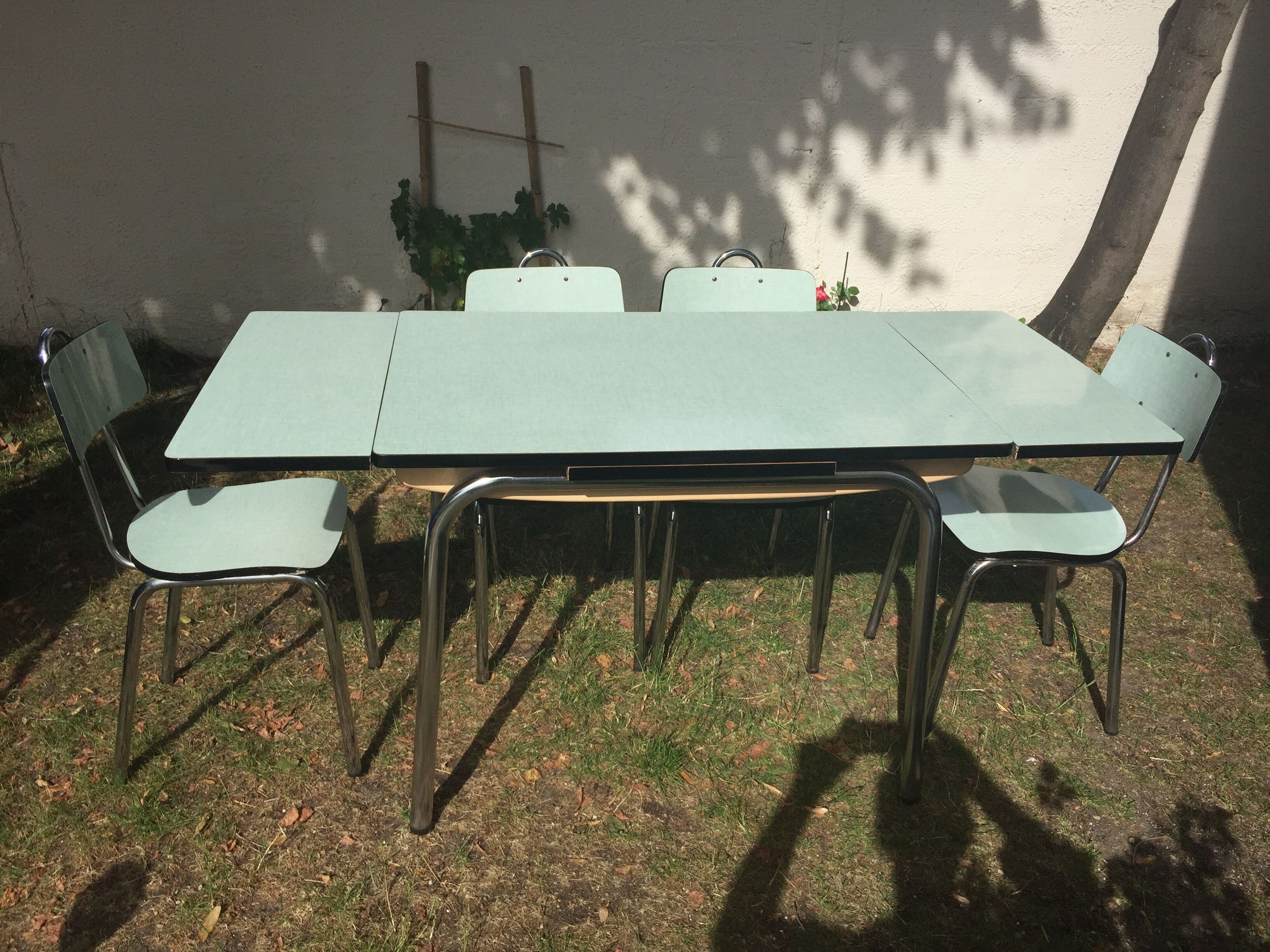 Table and 4 green water formica chairs 60's