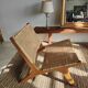 Reclining armchair in natural wood and woven rattan