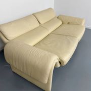 Two-seater designer sofa De Sede DS-2011 in cream leather with adjustable backrest.