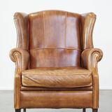 Graceful, stylish, timeless and comfortable wing chair made of cowhide in English style