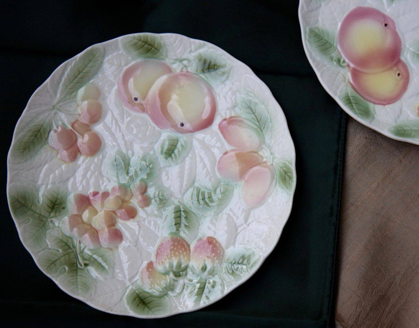 Two slip plates decorated with fruit.