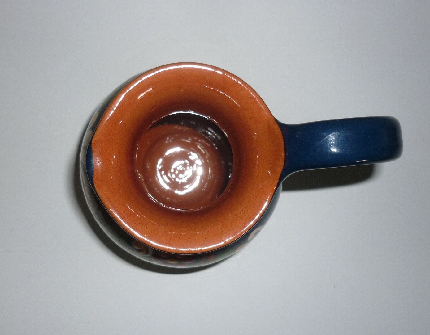 Blue glazed earth pitcher and flowers