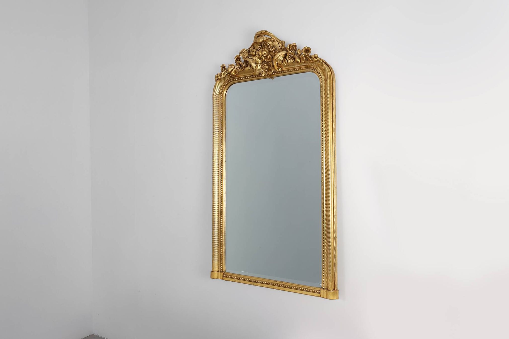 Baroque mantel mirror in carved wood and gilded plaster, France circa 1850.