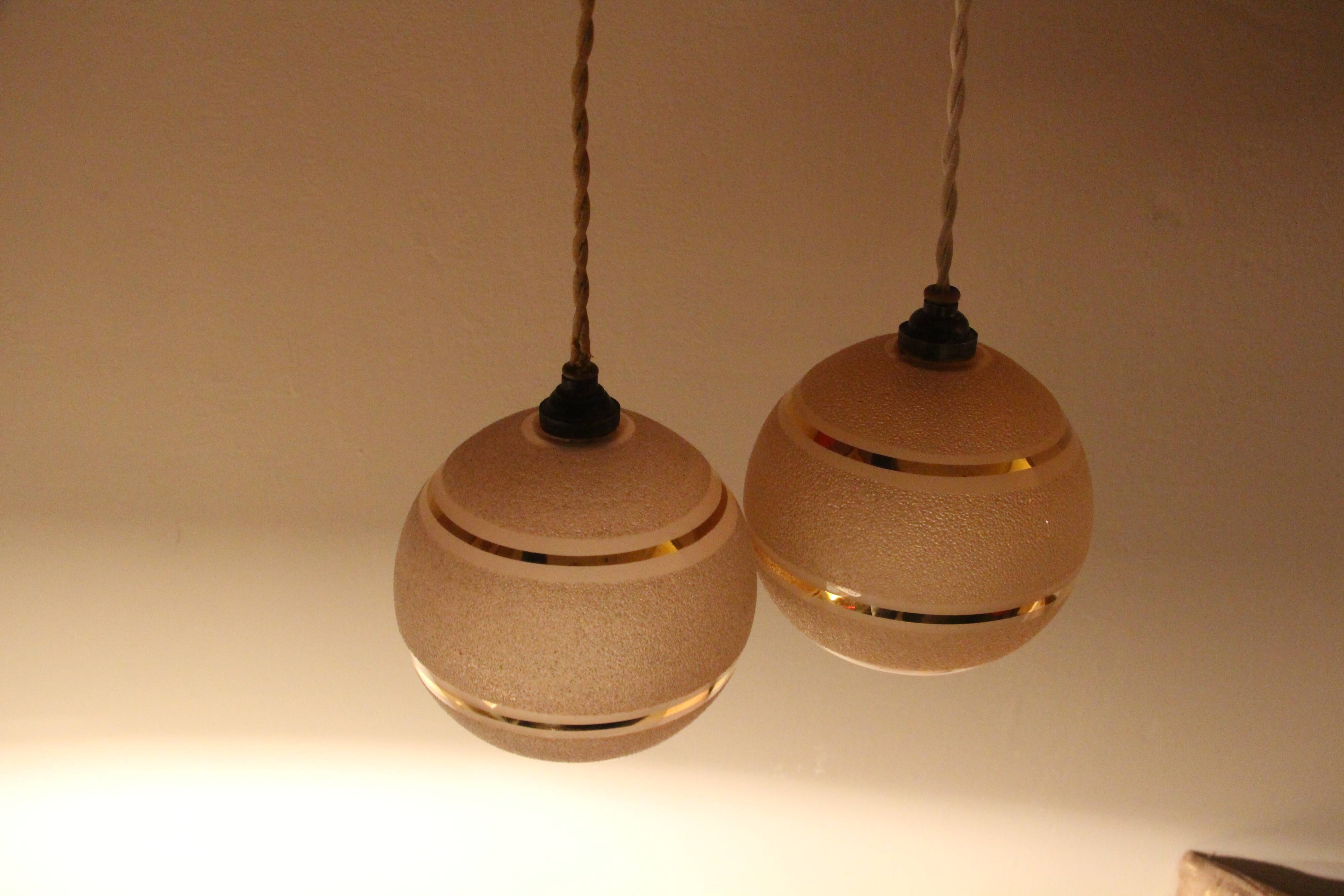 Set of two Art Deco pendant lamps in pink and gold glass