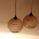Lot de deux suspensions Art Déco en verre rose et doré