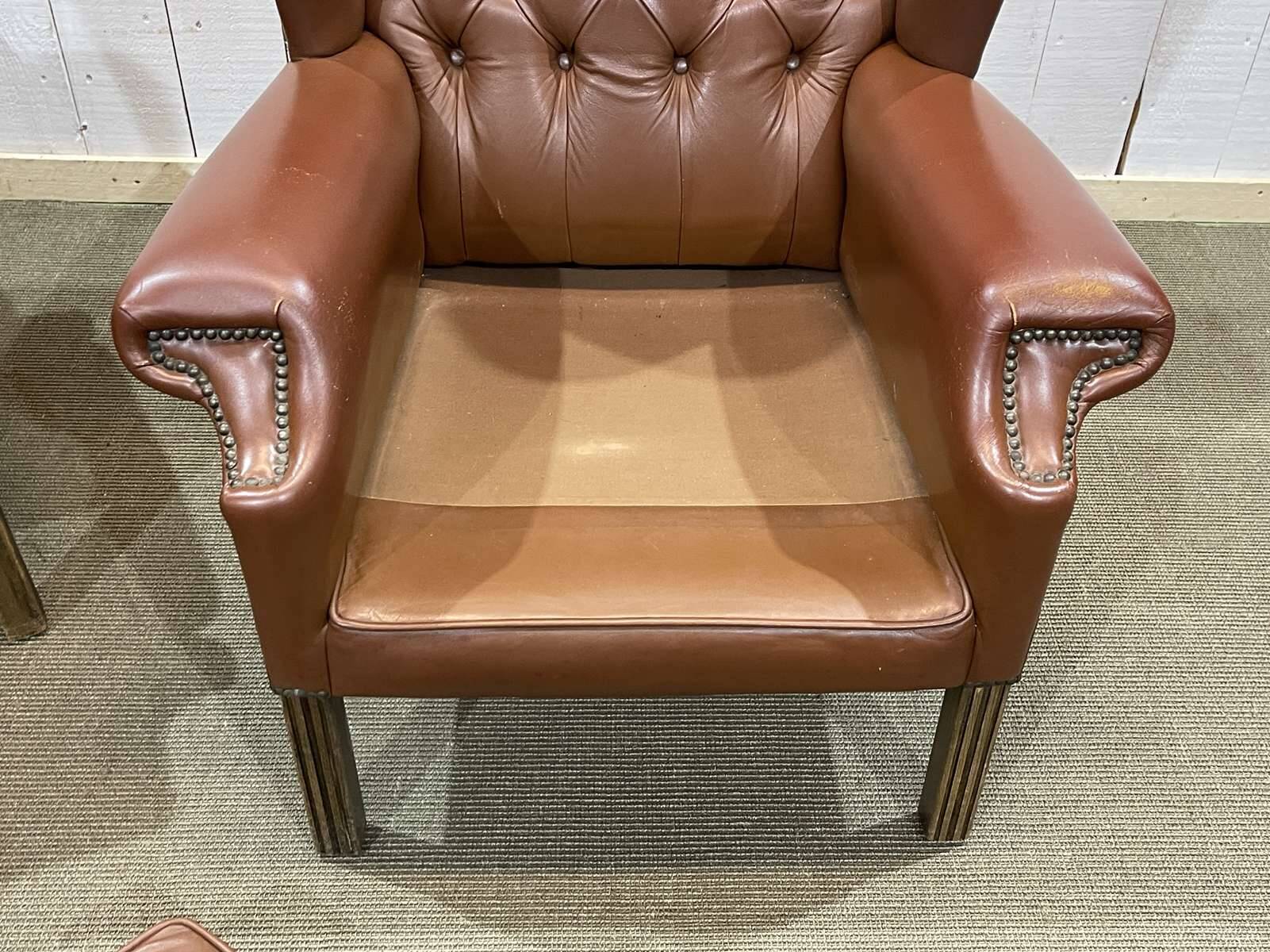 Pair of brown leather wingback Chesterfield armchairs from the 1970s.