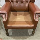 Pair of brown leather wingback Chesterfield armchairs from the 1970s.