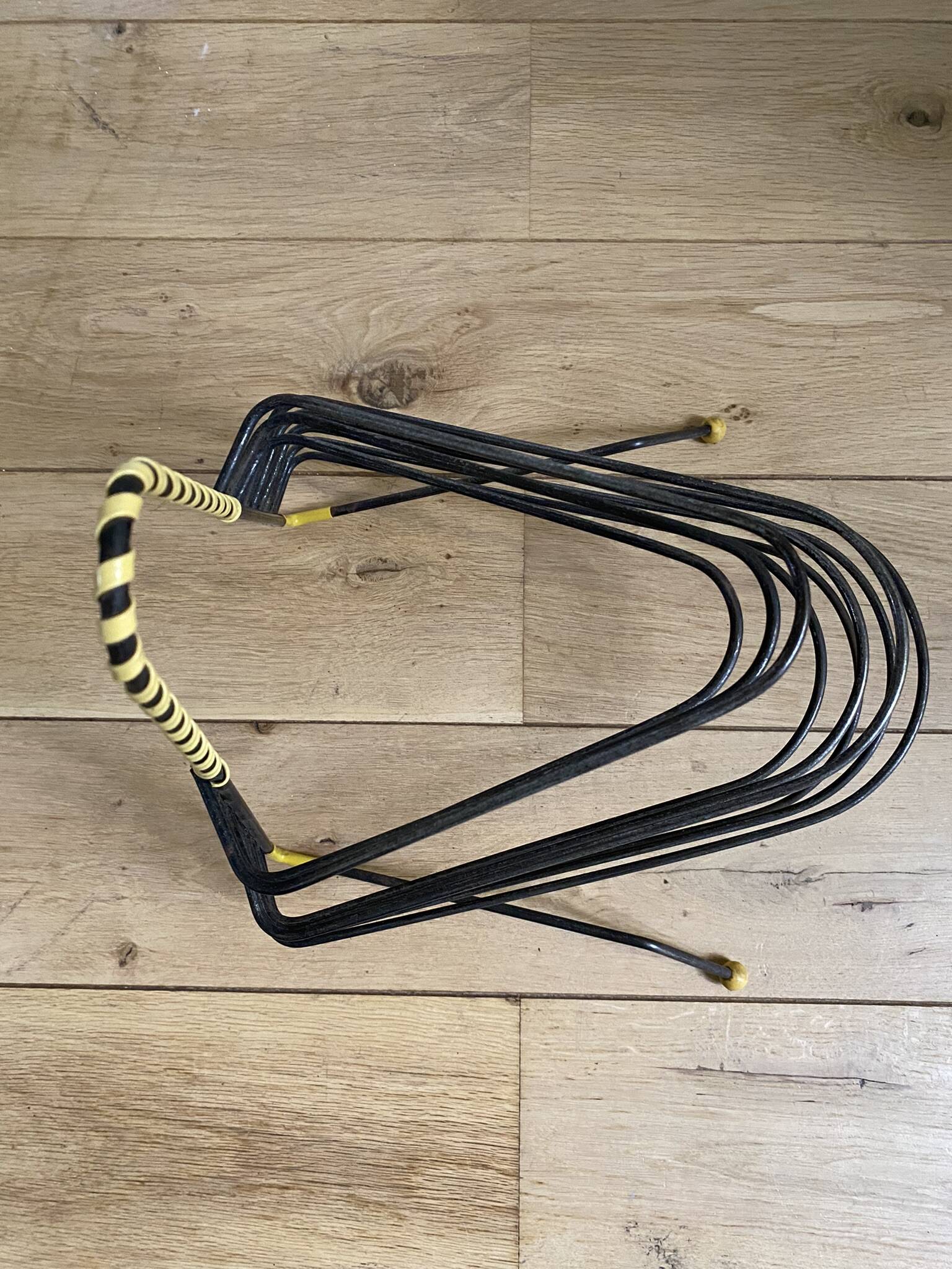 Black metal vinyl record holder and yellow scoubidou from the 60s