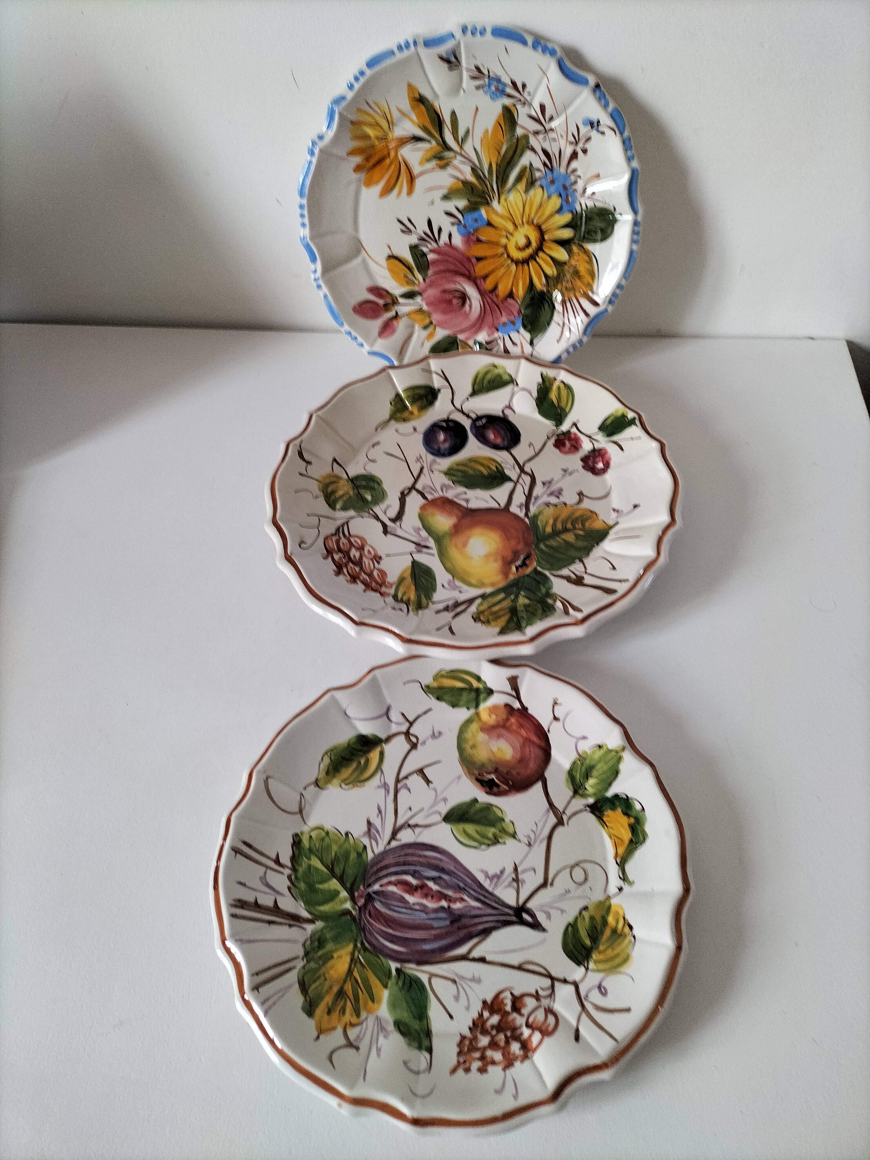 Set of three earthenware plates from Bassano, hand-painted with fruit and flower designs.
