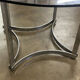 Dining table in chrome metal and smoked glass.
