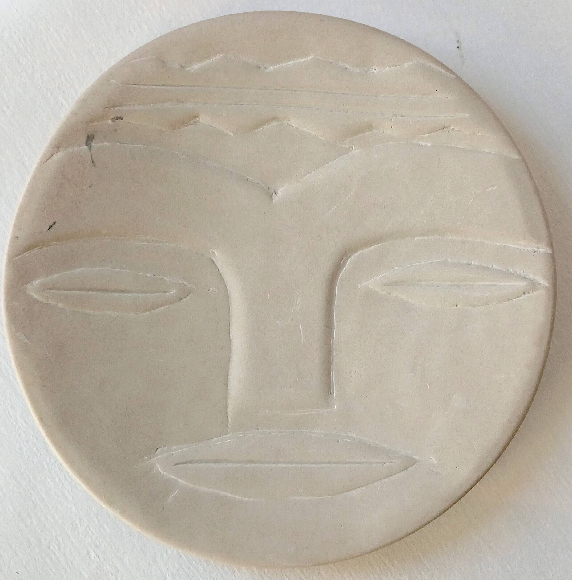 Plate "head with mask" natural stone hand carved