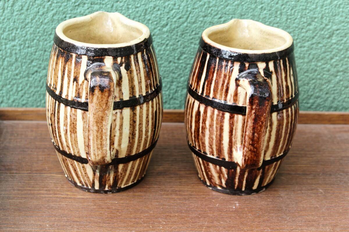 Pair of trompe l'oeil bistro pitchers, barrels