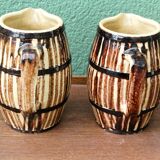 Pair of trompe l'oeil bistro pitchers, barrels