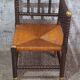 Fireplace corner chair in Louis XIII style, turned wood with braided rush, 19th century.