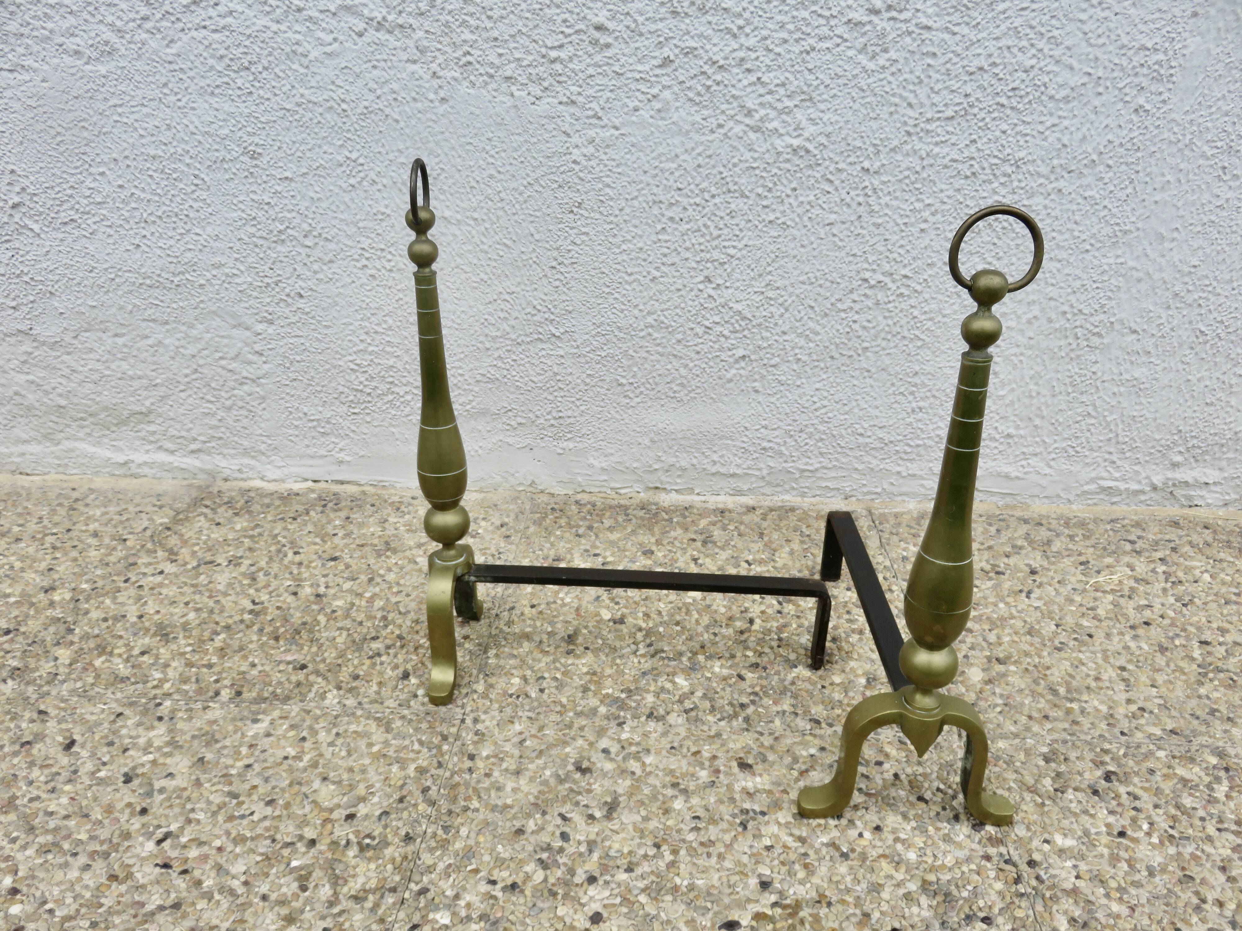 Pair of Neo-classical andirons, in solid bronze, 1920s-1930s.