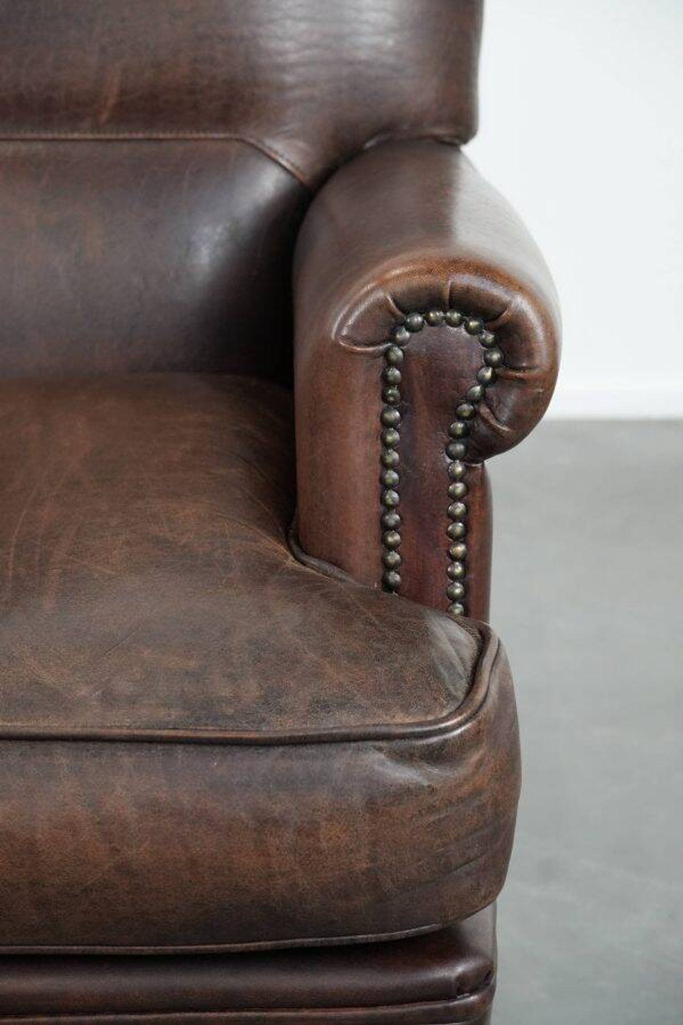 Characterful sheep leather armchair with a beautiful deep colour