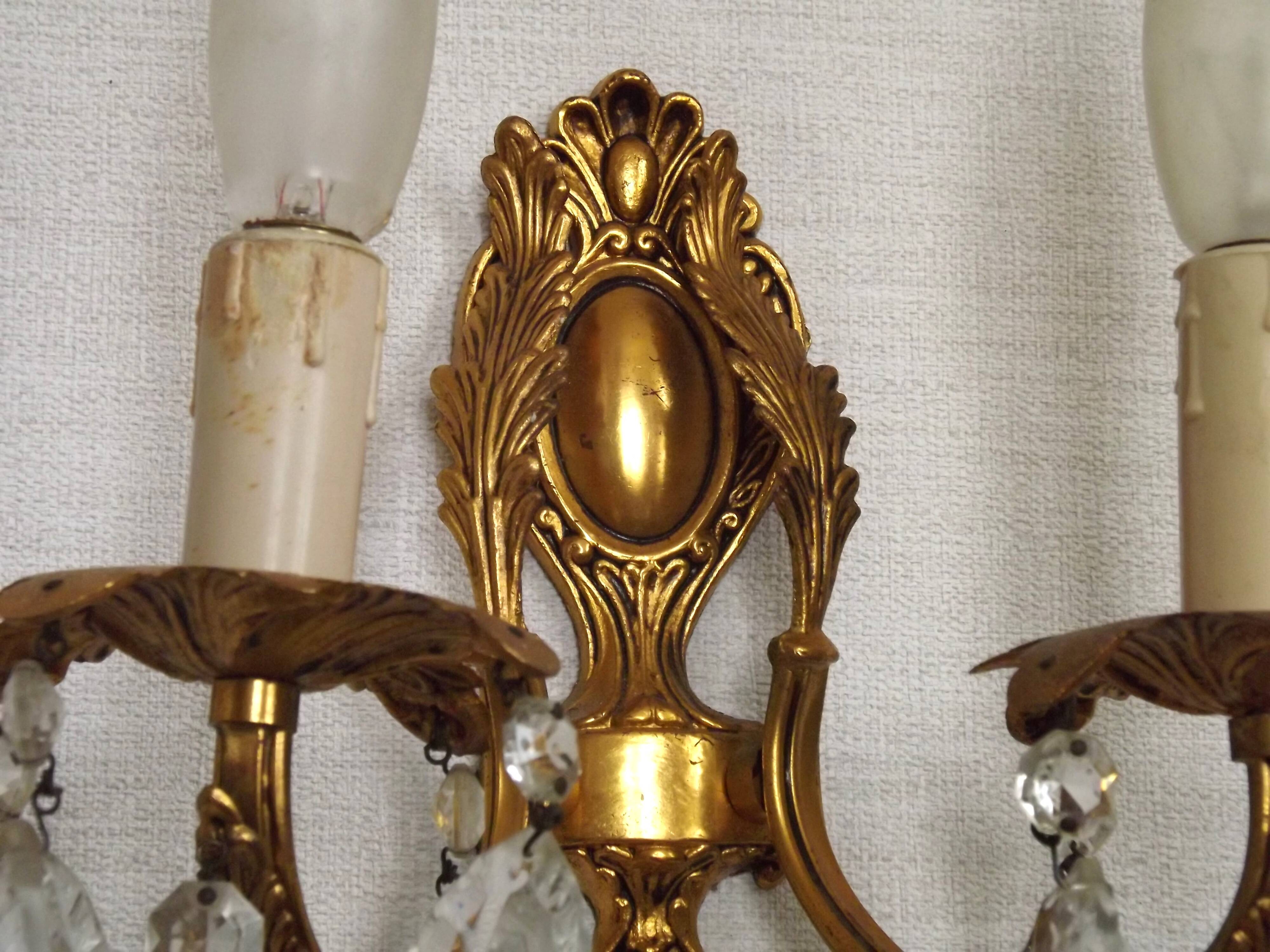 Pair of antique 2-light wall sconces in bronze with crystal pendants, Spain.