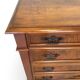 Antique walnut commode with bronze handles in the shape of a lion's mask,