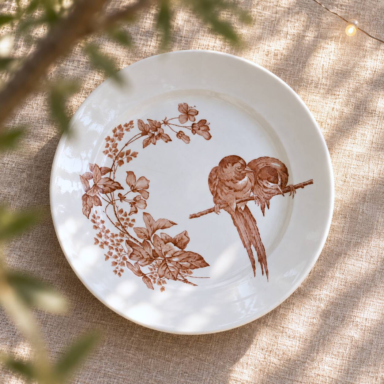 Large round dish from around 1870 signed Longwy with birds in sepia ironstone.