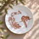 Large round dish from around 1870 signed Longwy with birds in sepia ironstone.