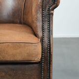 Vintage sheepskin club armchair with character and a beautiful patina