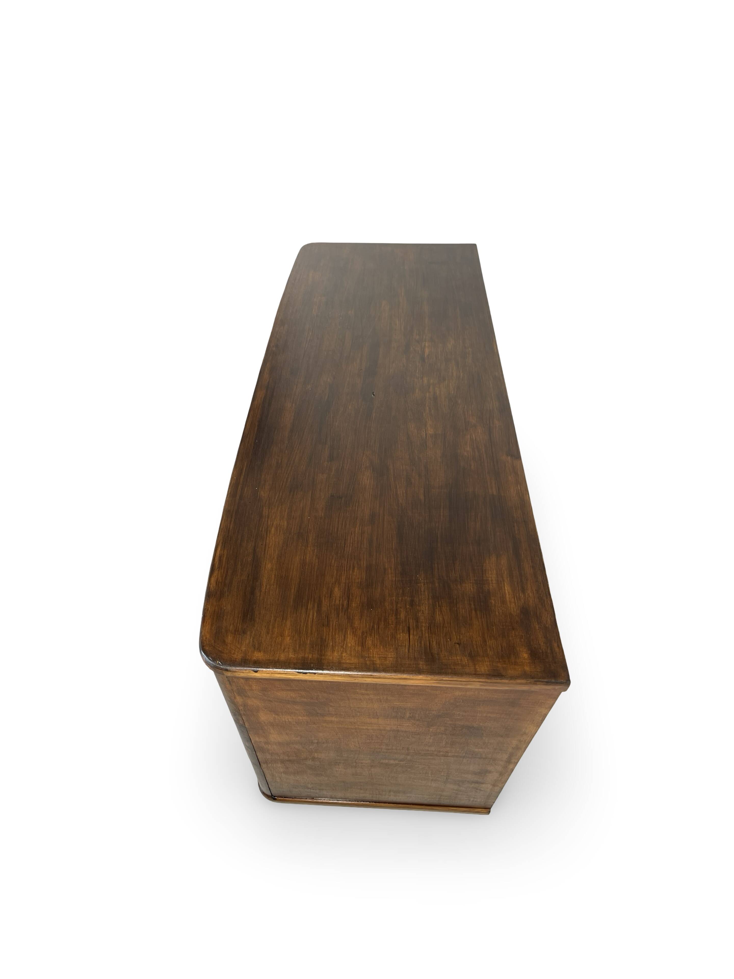 A vintage Italian chest of drawers, made of veneered walnut and solid wood,