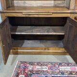 Library in walnut and oak from the early 20th century with its central clock.