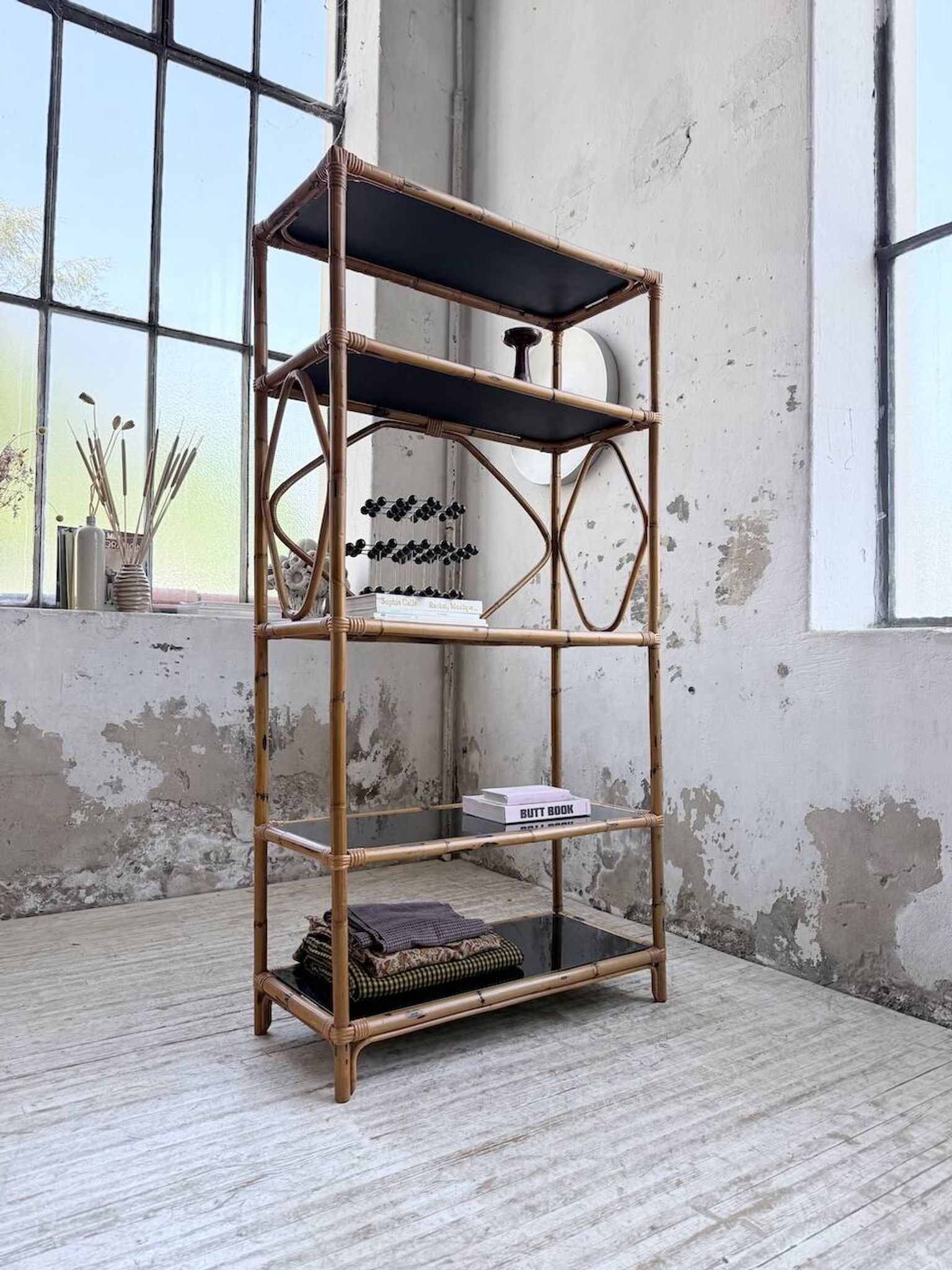 Rattan bookshelf and black glasses