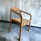 Solid wood chair with woven seat and armrests