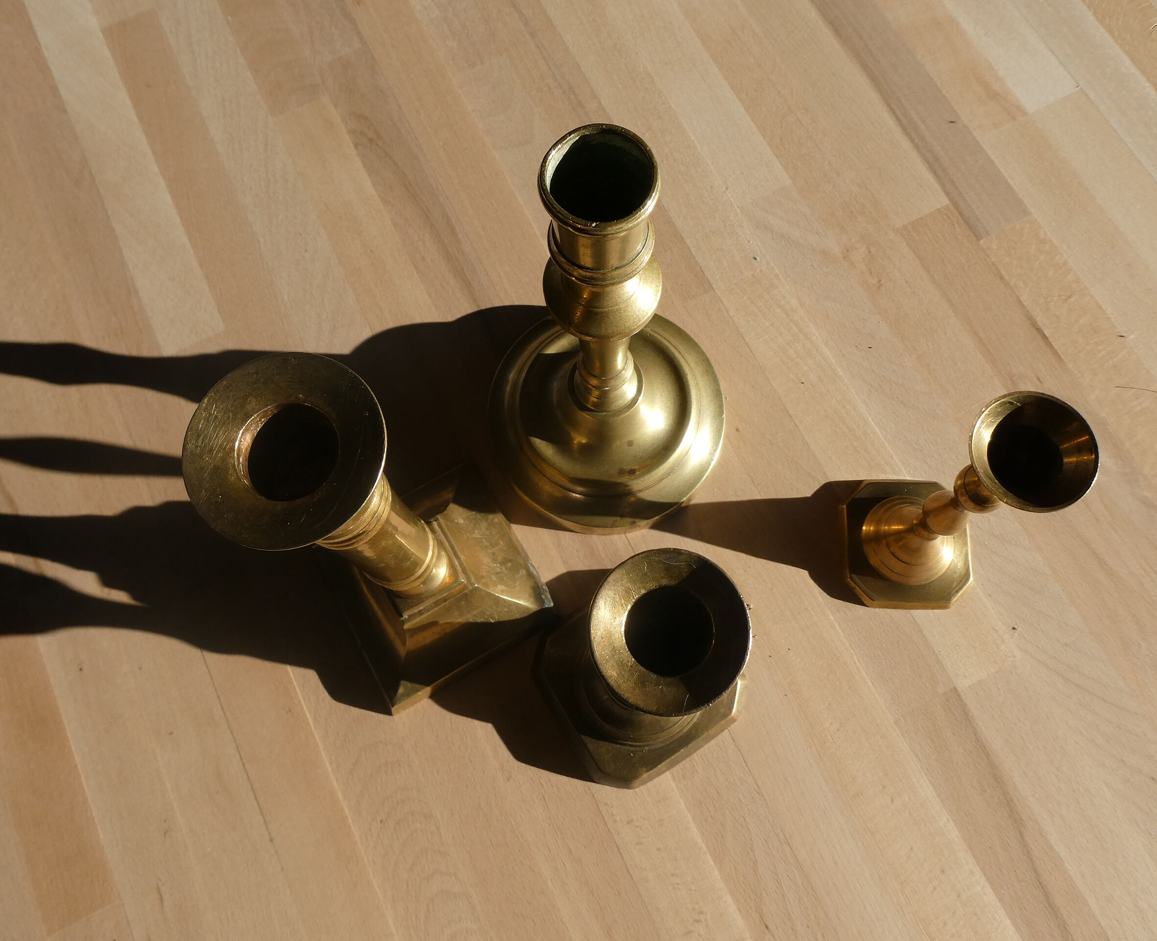 Set of 4 old candle holders in golden brass