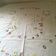 Oval tablecloth and napkins in white cotton embroidered in color