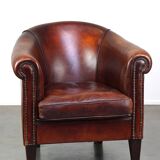 Very luxurious dark brown sheepskin club chair with a more than beautiful patina