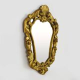 Old wall mirror in wood and gilded stucco with shell decoration, Louis XV style pediment mirror